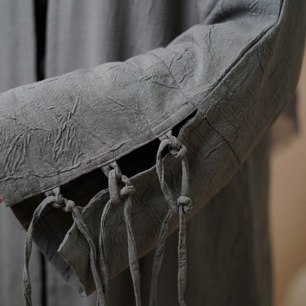 grey-tassel-abaya — macro